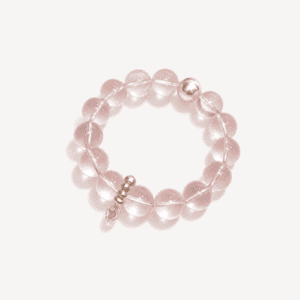 Pink rose quartz beaded bracelet with silver accents on white background.
