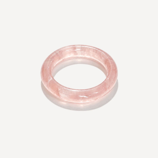 Pink rose quartz bracelet on a white background for jewelry.