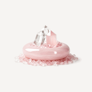 Rose quartz crystal tower on pink ring with small crystals around it.