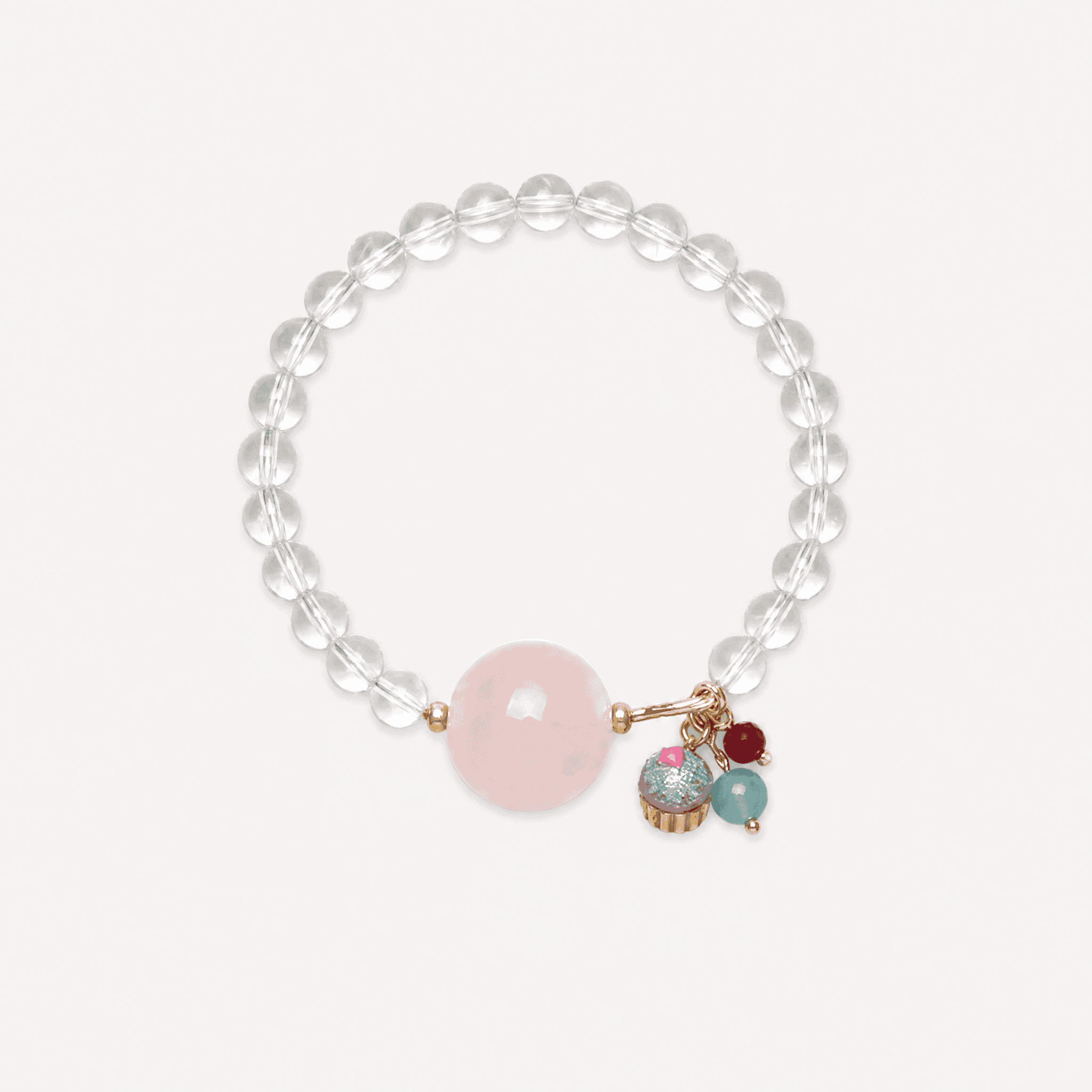 Elegant cupcake charm bracelet with clear quartz and rose quartz beads for jewelry lovers.