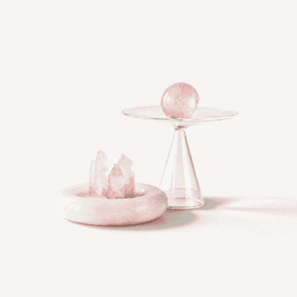 Rose quartz crystal set with a sphere and cluster on a glass stand.