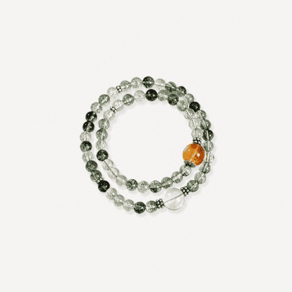 Elegant green phantom quartz bracelet with orange accent bead on white background.