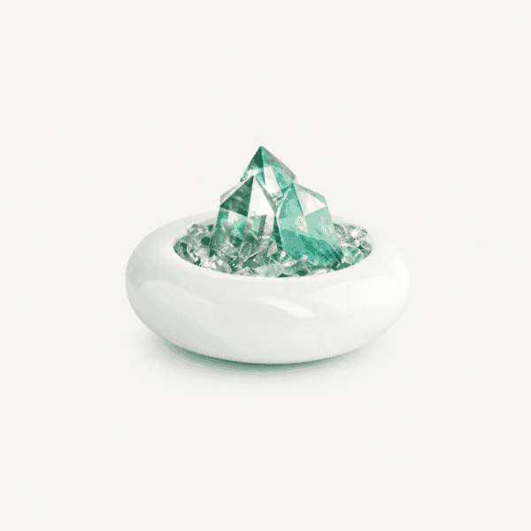 Elegant fluorite crystal sculpture in a white ceramic bowl.