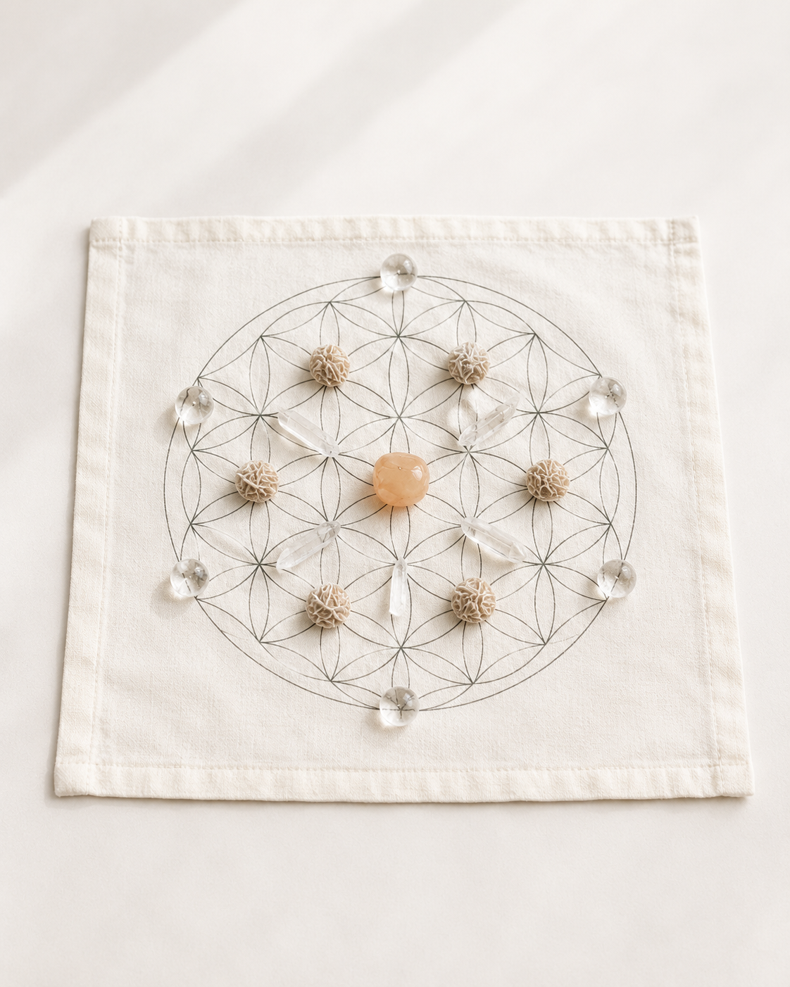 Manifestation crystal grid arranged on a soft white cloth