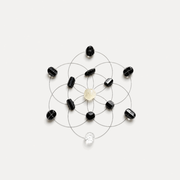 Crystal grid with black and clear stones on white background.